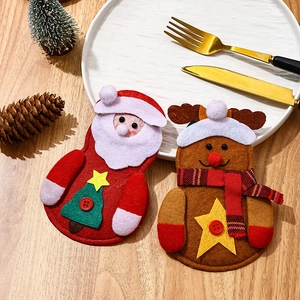Close-up of Santa and reindeer felt cutlery holders on a festive Christmas dining table