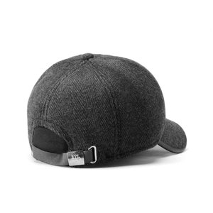 Detailed view of the dark gray tweed cap with leather strap and silver metal buckle