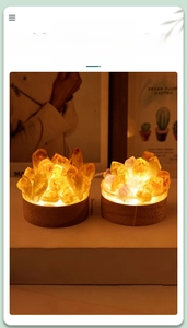 Close-up of natural amethyst crystal cluster night light on a round solid wood base