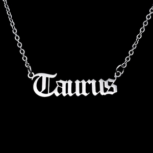 Close-up of Taurus gothic letter pendant on a polished stainless steel chain