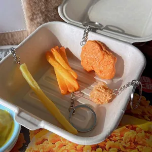 Realistic PVC fast food keychain set featuring French fries and fried chicken nuggets