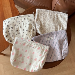 Set of four floral cotton drawstring pouches for travel storage with simple wish labels