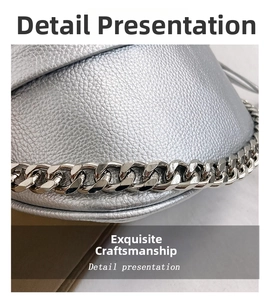Detail of silver crossbody bag featuring litchi grain texture and chunky metal chain