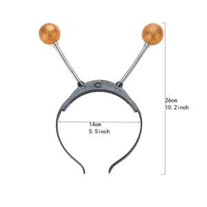 Detail view of alien headband with orange glitter bouncy balls on metal springs