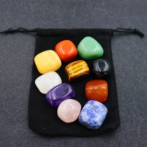 Polished natural crystal set featuring seven chakra stones and black drawstring bag