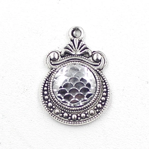 Close-up of 12mm silver scale pendant charm with moon pattern for DIY jewelry making