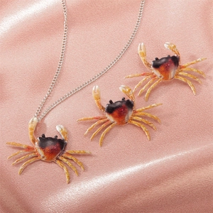 Conjunto retro exagerado de collar y pendientes de cangrejo con degradado naranja realista