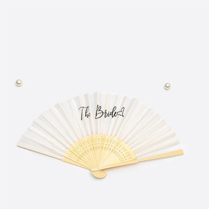 White bridal hand fan with black The Bride text and decorative bamboo wooden frame