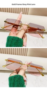 Detail of rimless square sunglasses with gold frame, gradient pink lenses and wood grain temples