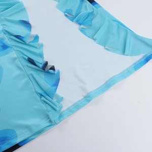 Détail de la robe à fleurs bleues avec bords à volants et coutures de finition soignées