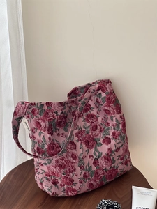 Détail de la texture jacquard rose vintage sur le sac à épaule en toile sous lumière naturelle