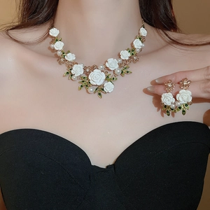 Close-up of floral necklace with white roses, pearls and crystals on a model