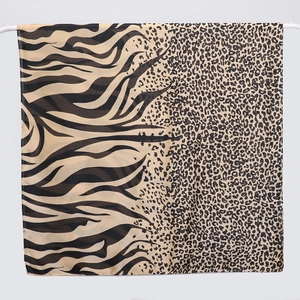 Close-up of leopard and zebra print silk scarf with polished satin texture and detail