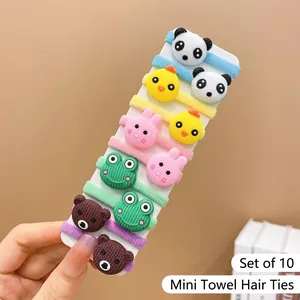 Close-up of 10-piece cartoon animal towel fabric elastic hair ties held on a card