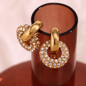 Macro detail of 18K gold plated hoop earrings with micro-pave crystal donuts