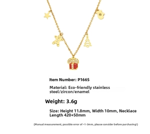 Detail of 18K gold plated necklace with Christmas enamel charms and zircon details