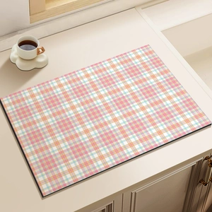 Absorbent pink checkered drying mat for kitchen countertops with a coffee cup setup