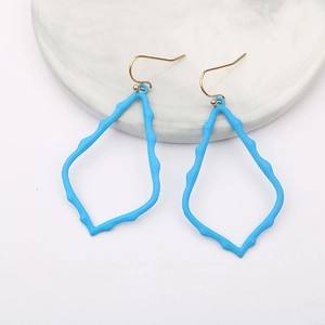 Detail of sky blue irregular geometric drop earrings on a marble tray background