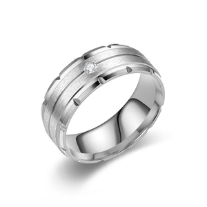 Detailed macro view of silver titanium steel men's ring with central zircon and notched edges