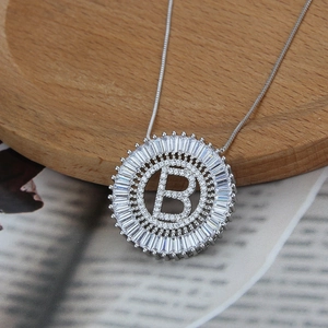 Macro shot of silver initial B pendant necklace with pavé cubic zirconia setting