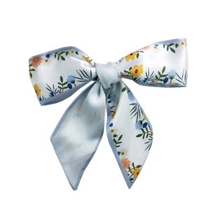 Floral print satin hair ribbon with light blue trim in a long minimalist bow style