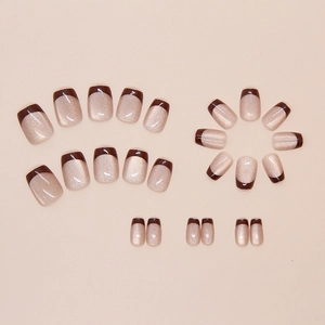 Detail of short square champagne cat-eye press-on nails with dark brown French tips