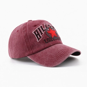 Washed burgundy cotton baseball cap with red star embroidery shown from a 45-degree angle