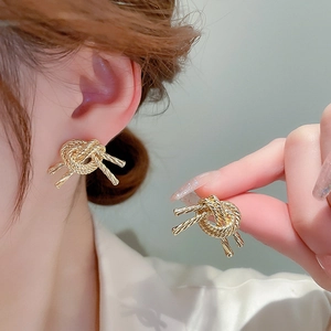Golden knotted rope stud earrings for women with twisted metal design and polished finish