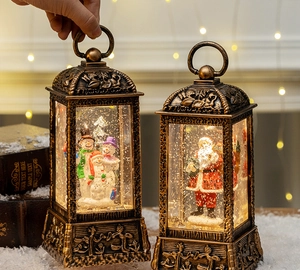 Close-up of vintage bronze Christmas lantern with snow globe and glowing warm LED light