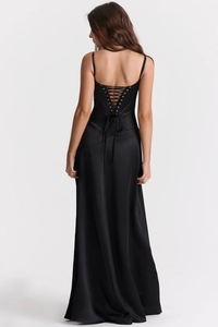 Detail of elegant black satin long dress with corset-style lace-up back design