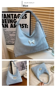 Detail of light blue bucket bag with silver butterfly emblem and pleated waterproof fabric