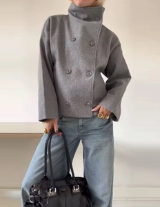Detail of grey wool blend cropped jacket with double-breasted buttons and lapel collar
