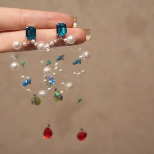Detailed macro of vintage colorful beaded earrings featuring resin accents and tassels