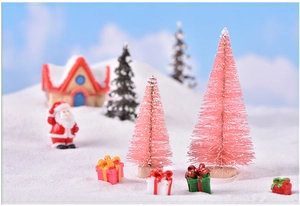 Miniature pink Christmas trees and Santa Claus set for winter snow scene diorama