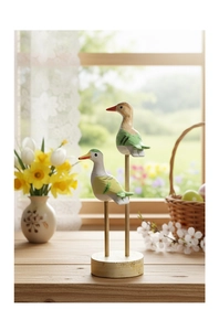 Detail of hand-painted wooden bird ornaments with natural wood grain on a round base