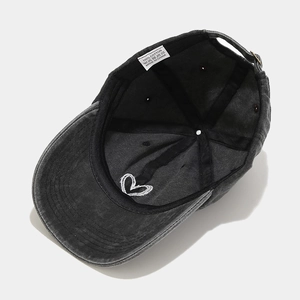 Internal view of dark gray washed cotton cap showing heart embroidery and black sweatband