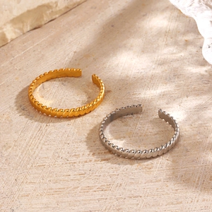 Minimalist 18K gold and silver plated stainless steel twisted rope open rings on stone base