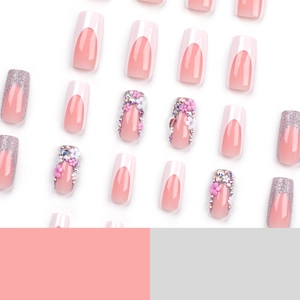 Pink and white French tip press-on nails with 3D floral accents and silver glitter