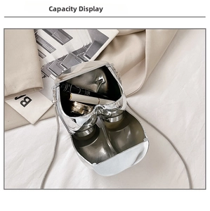 Interior view of silver heart-shaped hard shell bag with lipstick and compact powder