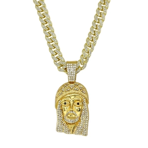 Close-up of a gold-plated Cuban link necklace featuring a sparkling diamond-set Jesus pendant