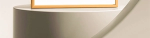 Close-up of the elegant gold metal frame base resting on a minimalist display stand