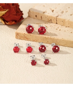 Various sizes of sterling silver stud earrings with sparkling red round-cut gemstones