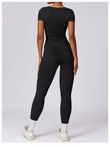 Rear view of slim fit black yoga t-shirt and high waist leggings for fitness and sports
