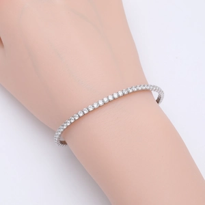 Close-up of S925 sterling silver tennis bracelet with round zircon pavé setting on wrist