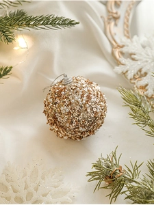Detail of champagne gold and white pearl Christmas balls with sequins on pine branches