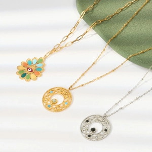 Detail view of titanium steel necklaces with enamel pendants and geometric patterns