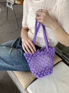 Detailed close-up of a purple hand-woven mesh hollow tote bag for summer beach outings