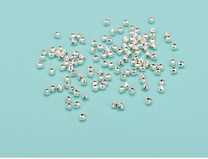 Close-up of heart-shaped silver spacer beads for DIY jewelry making and crafting