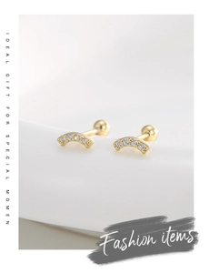 Detail of 14K gold plated curved stud earrings with zirconia and screw back design