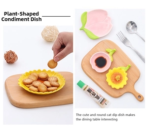 Detail of sunflower and peach shaped ceramic sauce dishes on a wooden board